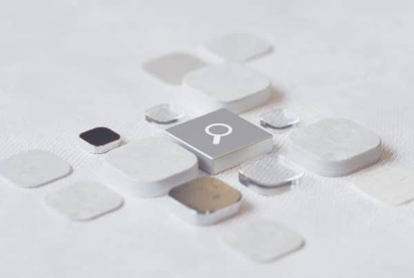 Close-up of square buttons, one with a magnifying glass symbol signifying search.